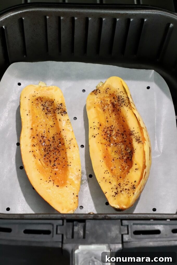 How to Cook Delicata Squash: Roast, Bake and Saute 9 seasoned raw delicata squash sliced in half in air fryer basket