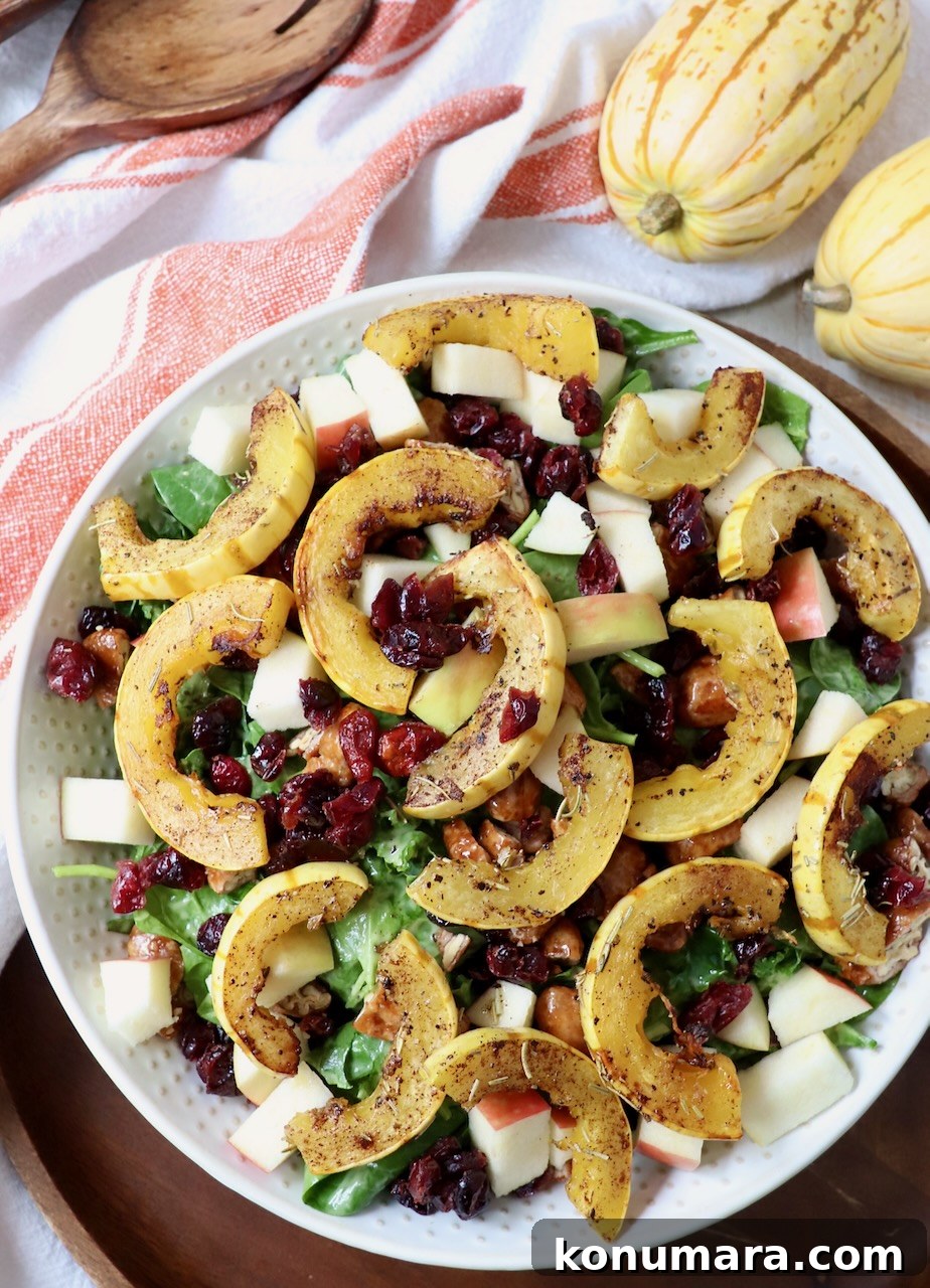 Roasted Delicata Squash Salad with Arugula and Feta 5 roasted slices of delicata squash on top of salad in large bowl