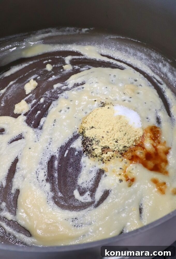 Creamy Homemade Mac and Cheese Recipe 4 a roux with hot sauce and spices in a large pot