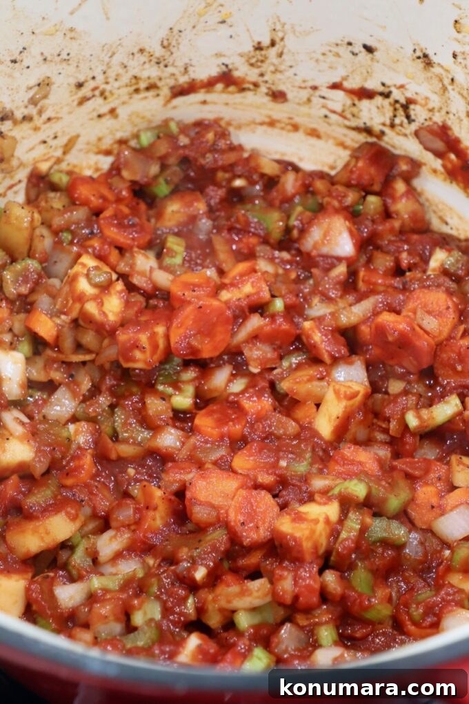 diced vegetables with tomato paste in dutch oven
