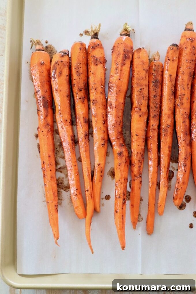 Honey-Glazed Carrots with Thyme and Garlic 5 honey glazed carrots on parchment lined baking sheet