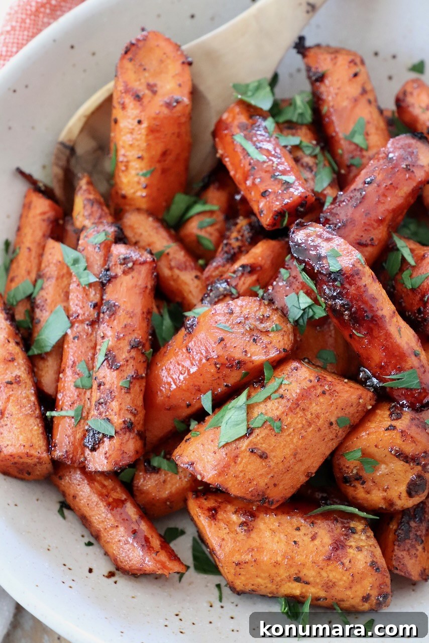 Honey-Glazed Carrots with Thyme and Garlic 6 sliced honey glazed roasted carrots in bowl with spoon