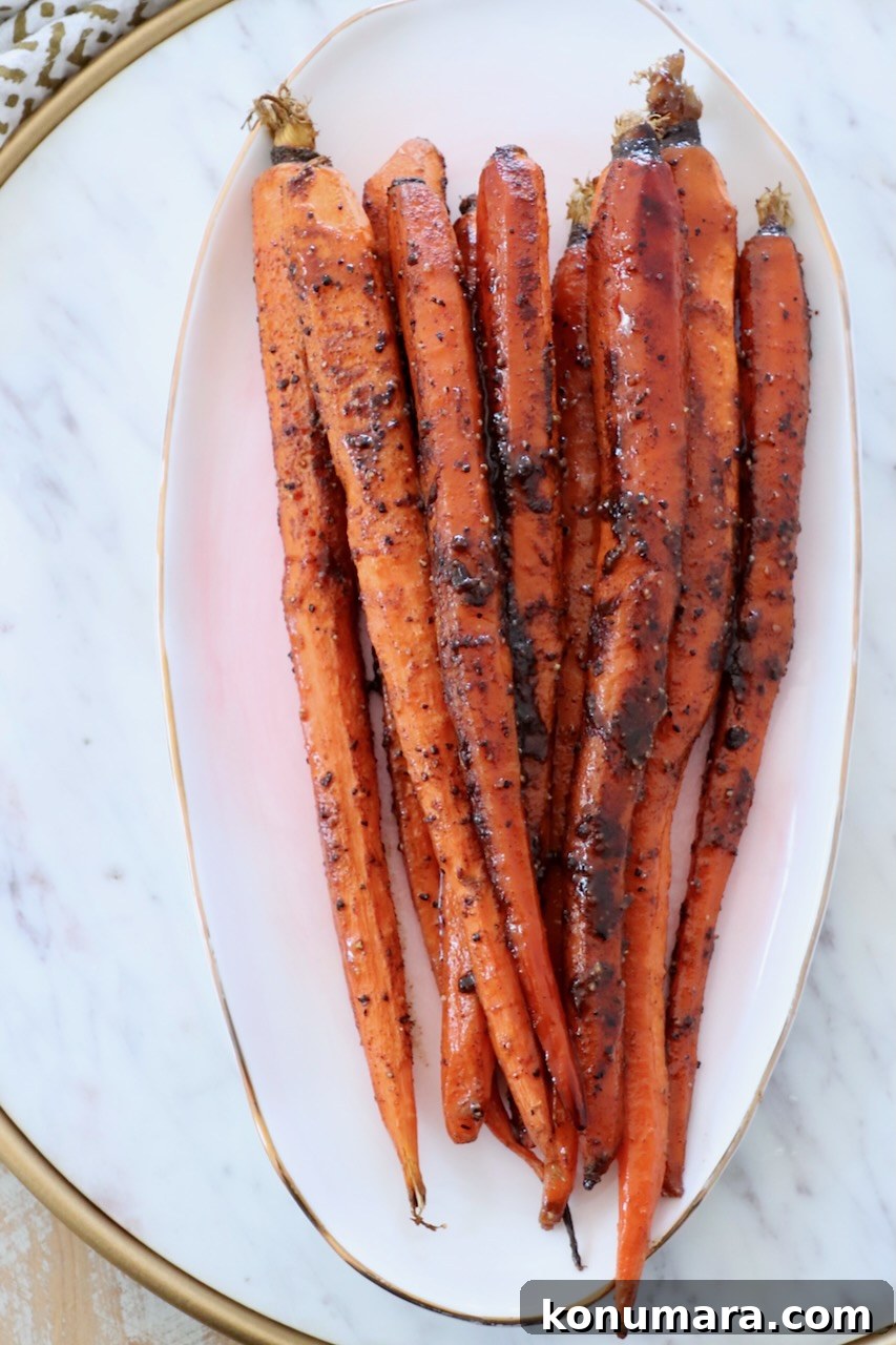 Honey-Glazed Carrots with Thyme and Garlic 7 glazed roasted carrots stacked up on plate