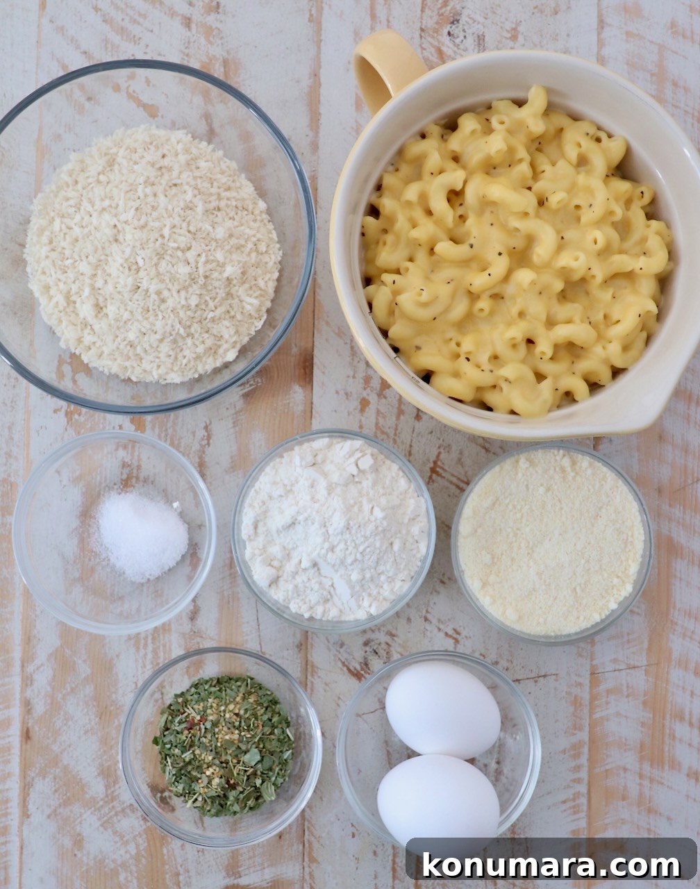 mac and cheese bites ingredients on white wood board