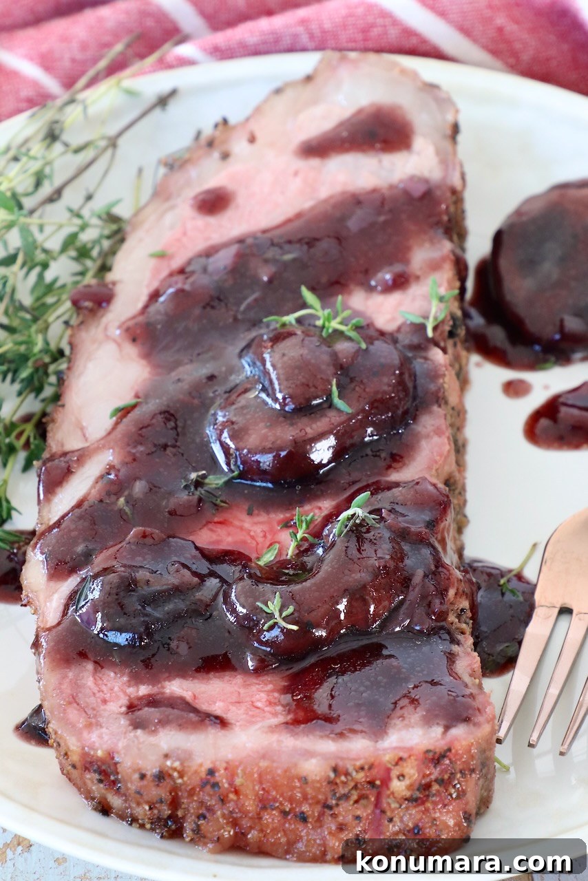 Smoked New York Strip Roast Recipe and Smoking Tips 11 smoked new york strip steak on plate, covered in red wine sauce