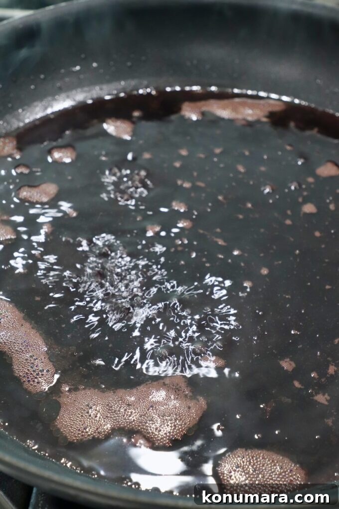 Smoked New York Strip Roast Recipe and Smoking Tips 10 red wine sauce in a skillet
