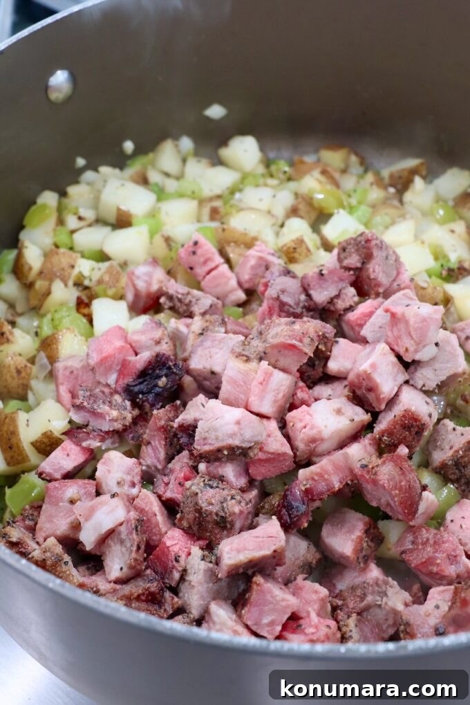 Skillet Philly Cheesesteak Hash with Peppers and Onions 6 cooked, diced steak in dutch oven with potato hash