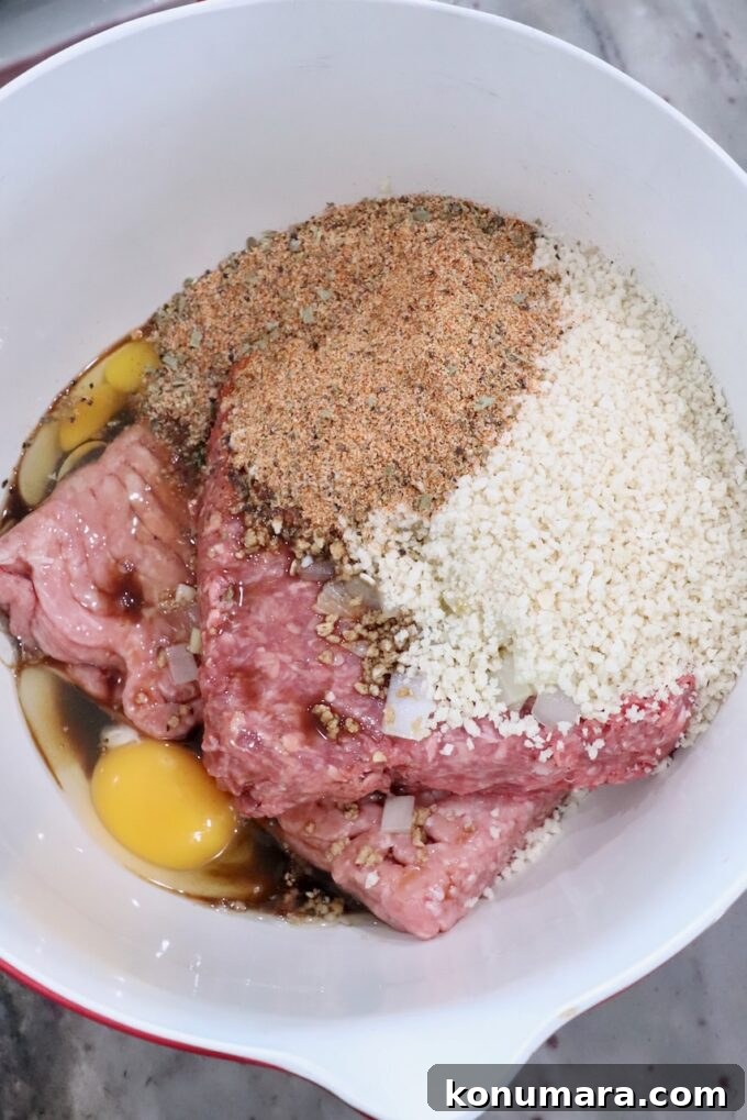 How to Smoke Meatloaf for Tender, Flavorful Results 5 seasoned ground meat in large bowl with breadcrumbs and egg