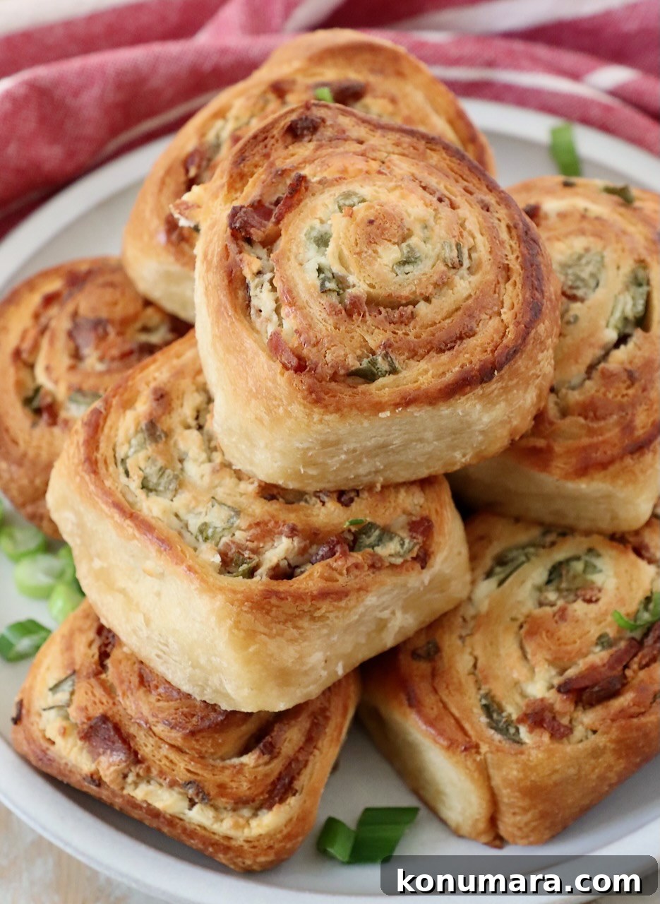 baked cheese filled crescent rolls stacked up on a plate