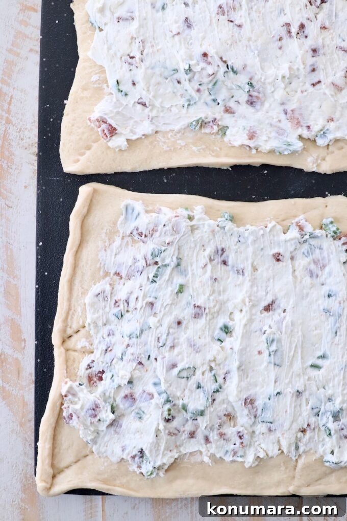 bacon and cream cheese spread on crescent roll dough