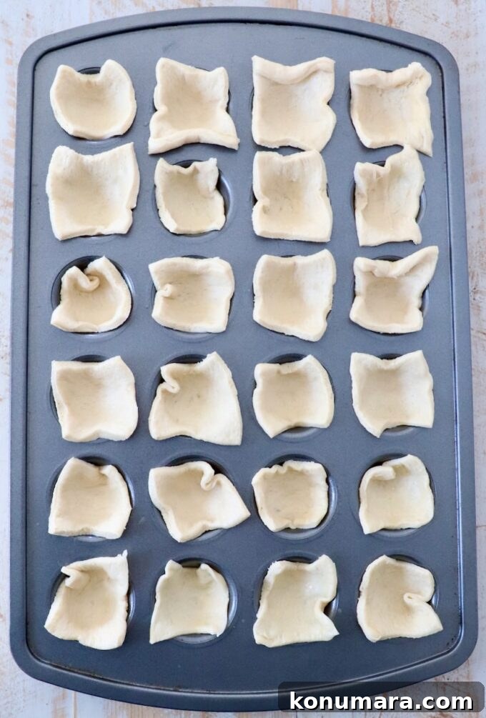 Cranberry Brie Bites Recipe with Puff Pastry 5 24 squares of crescent roll dough pressed into a mini muffin tin