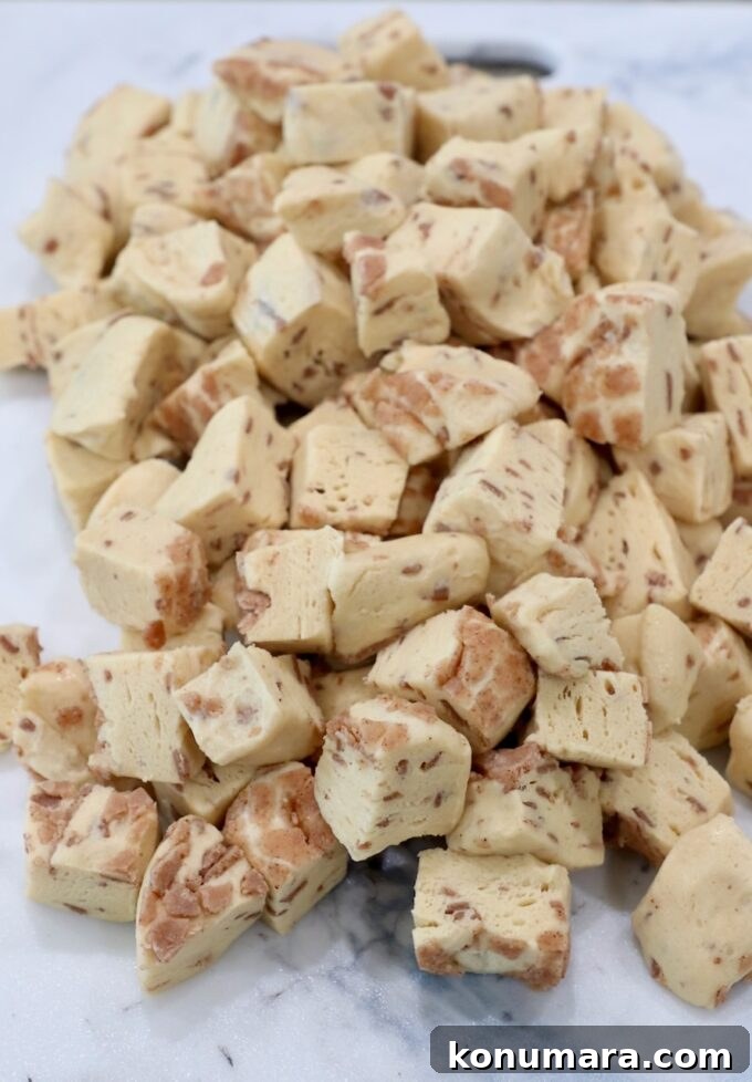 refrigerated canned cinnamon rolls diced up on a cutting board