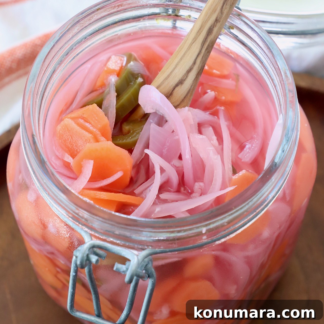pickled onions, carrots and jalapenos in large glass mason jar
