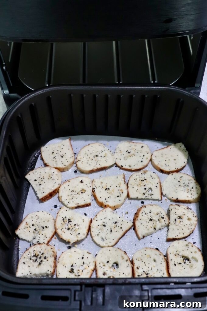 Crispy Homemade Bagel Chips: Recipe and Flavor Ideas 6 seasoned sliced bagel chips in air fryer basket