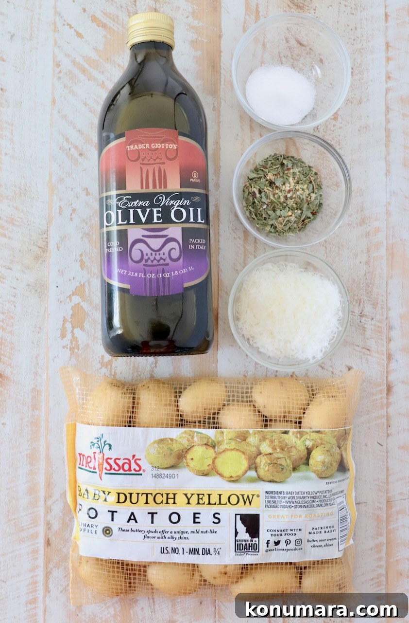 ingredients for roasted baby potatoes on a white wood board