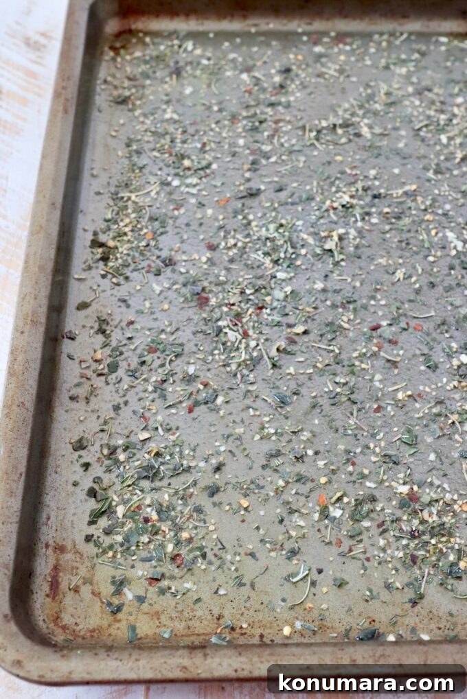 Italian seasoning sprinkled on baking sheet