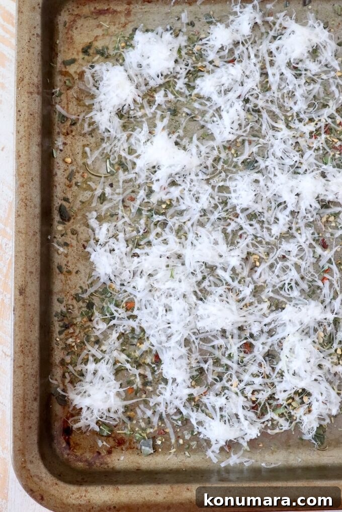 grated parmesan cheese and Italian seasoning on baking sheet