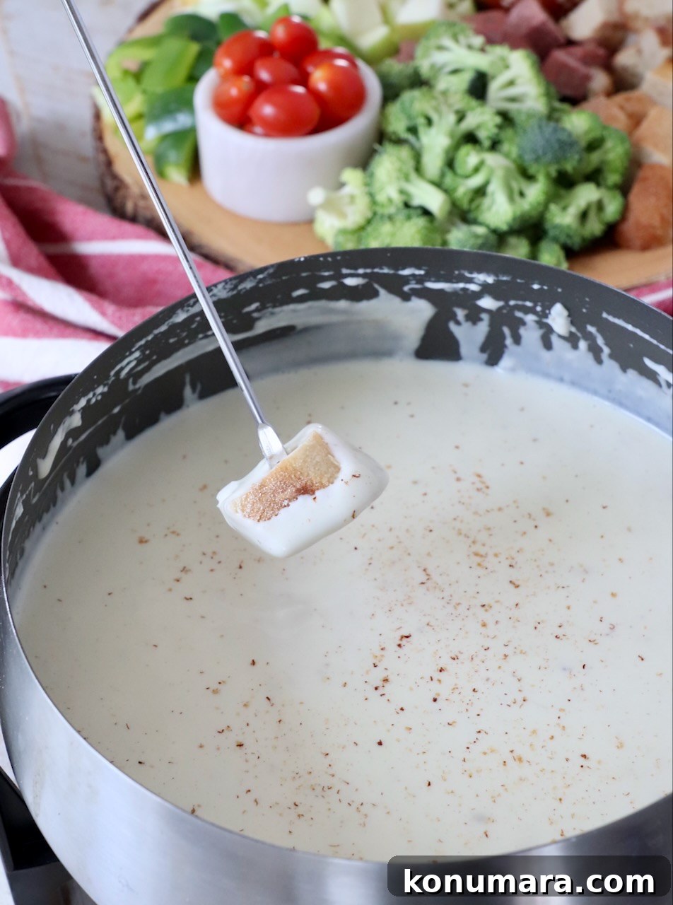 bread dipped into cheese fondue in pot