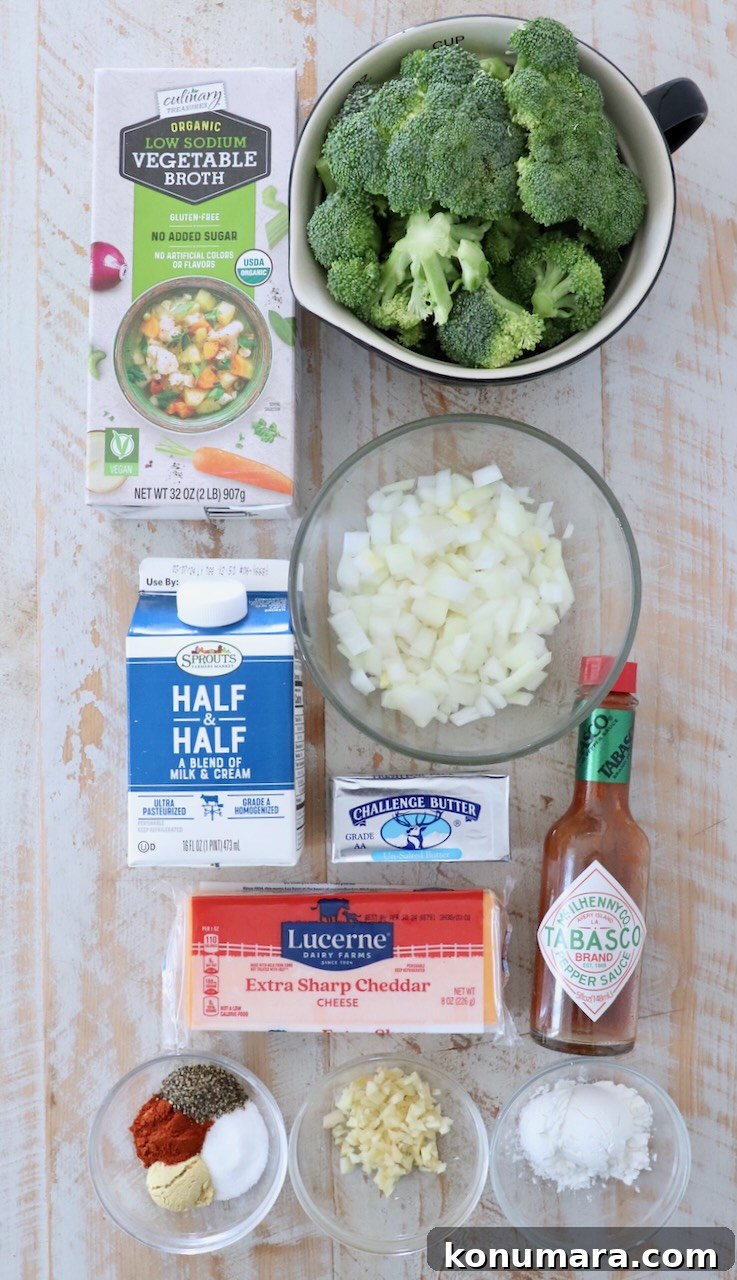 ingredients for broccoli cheddar soup on white wood board