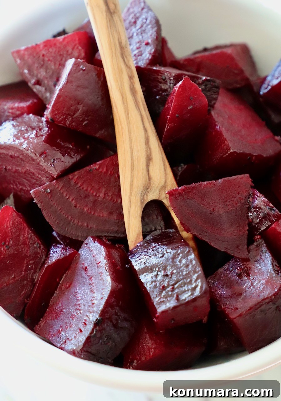 How to Cook Beets: Roast, Boil, and Sauté 20 cooked diced beets in bowl with wooden fork