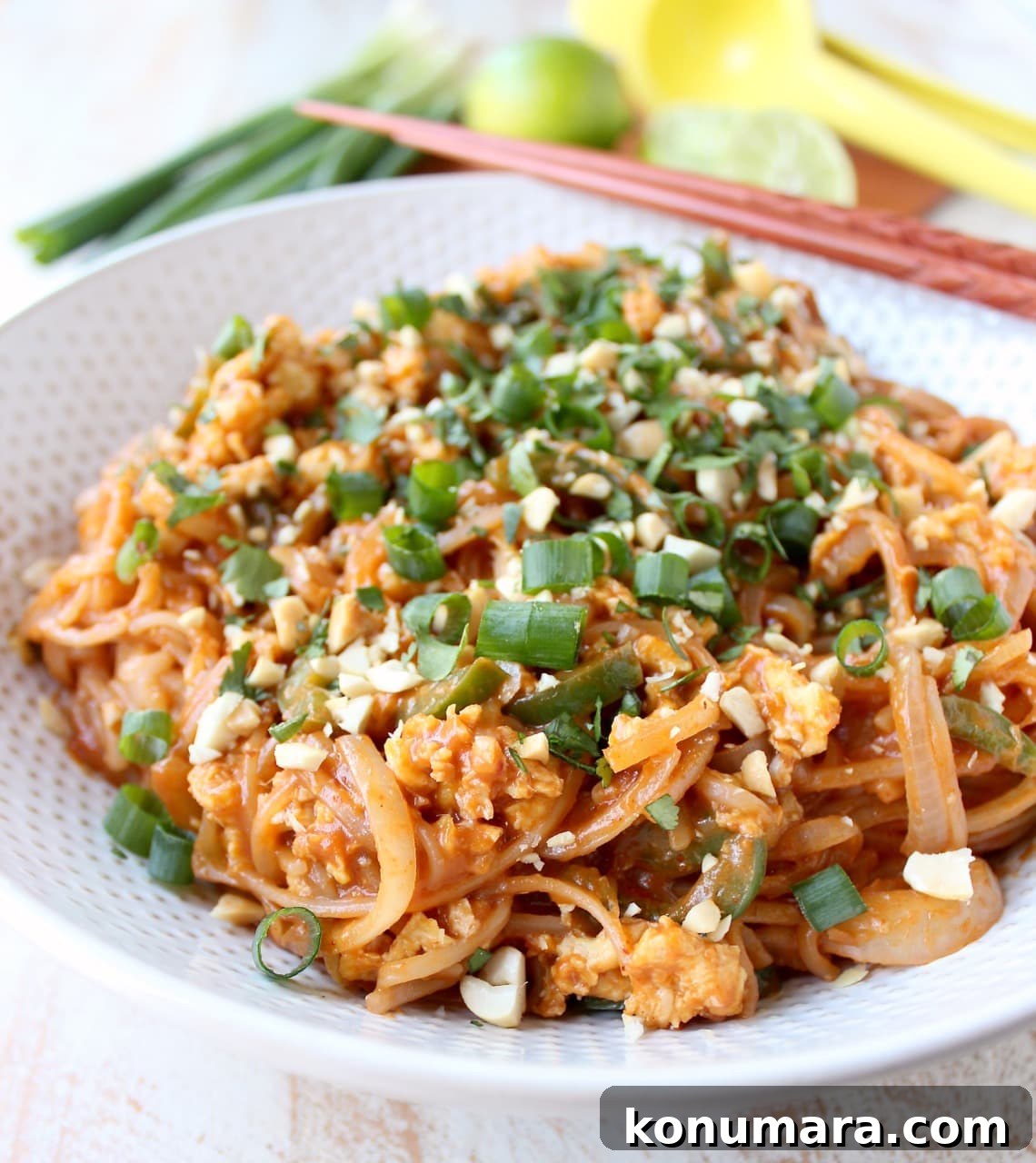 Pad Thai Recipe in bowl with eggs, green onions and peanuts