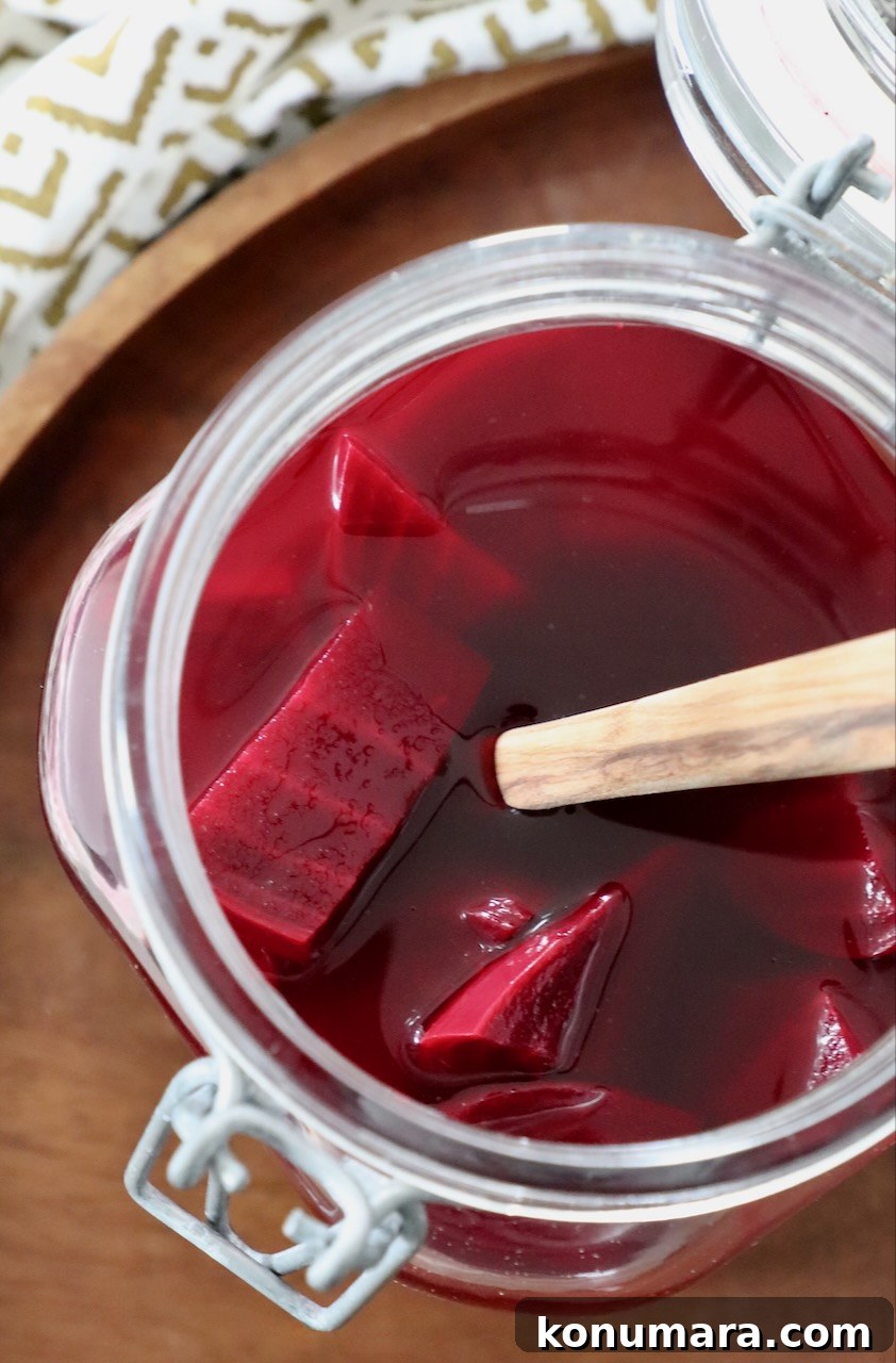 Tangy Pickled Beets Recipe for Vibrant Flavor 2 pickled beets in jar with spoon