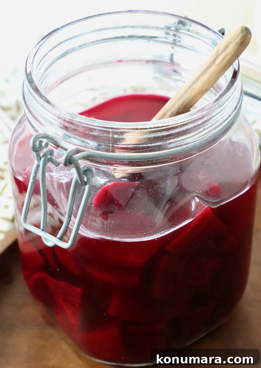 Tangy Pickled Beets Recipe for Vibrant Flavor 8 pickled beets in jar with wooden spoon