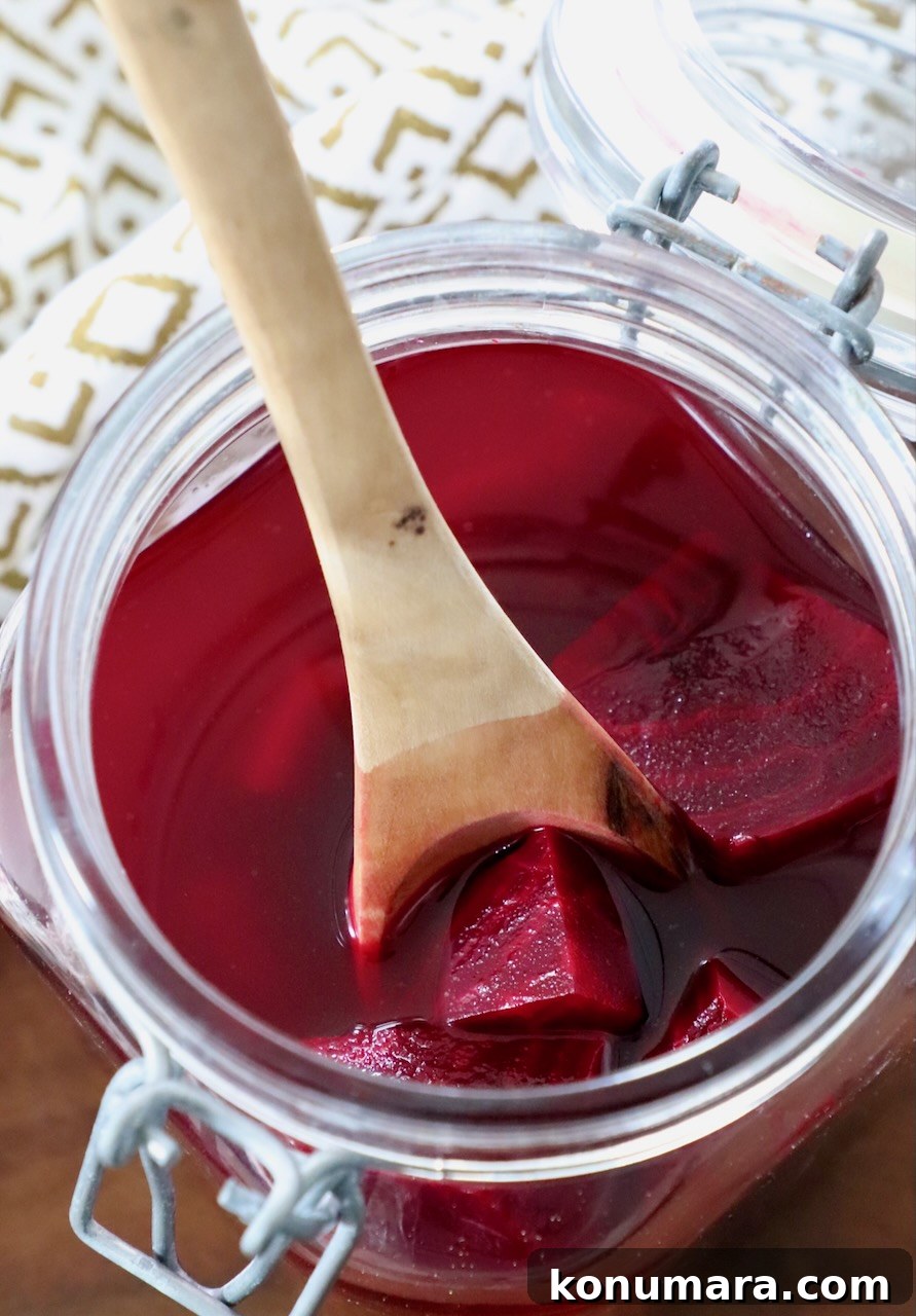 Tangy Pickled Beets Recipe for Vibrant Flavor 7 pickled beets in jar with wooden spoon