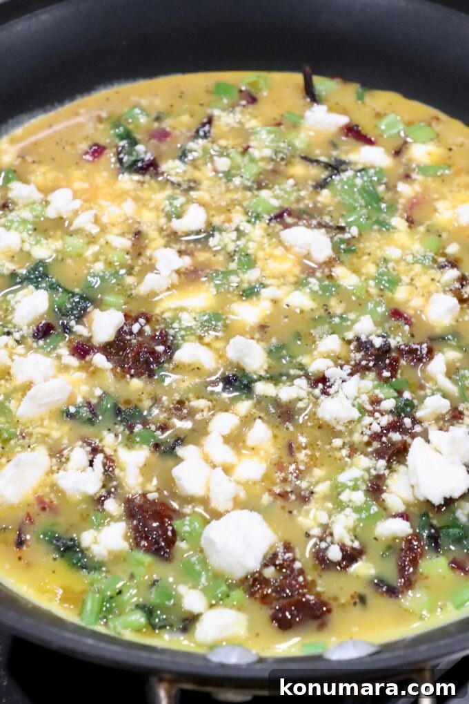 What to Do With Beet Greens: Recipes and Storage Tips 12 uncooked frittata in skillet topped with feta cheese crumbles
