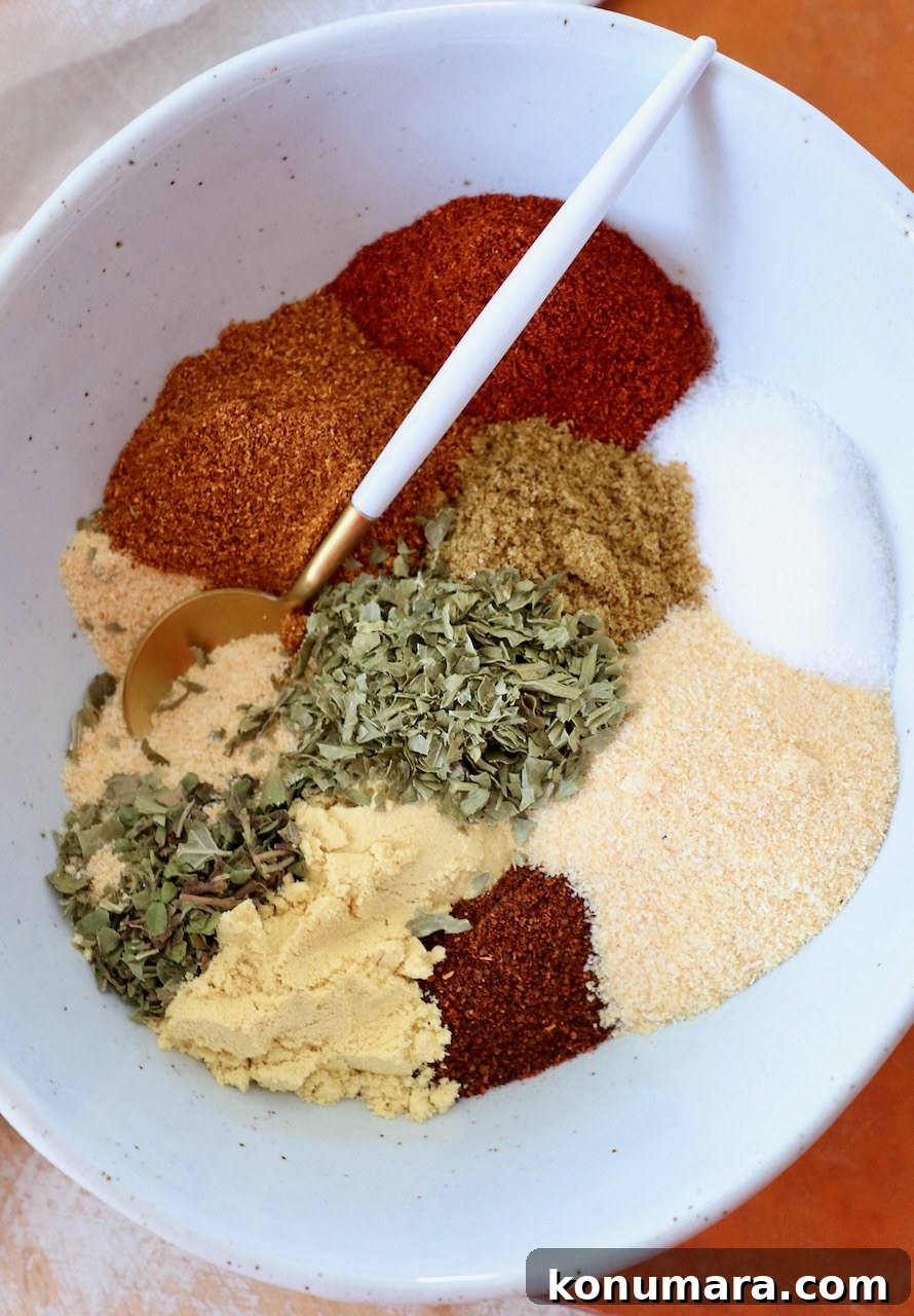dried herbs and spices separated in bowl with spoon