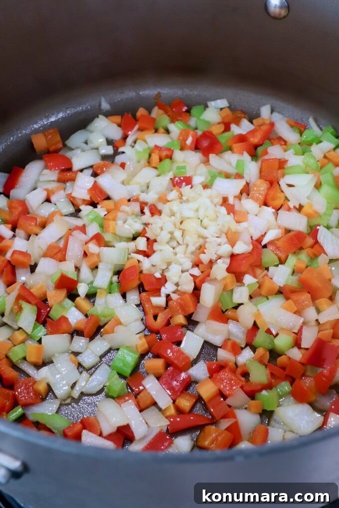 Smoky Southwest Black Bean Soup Recipe 4 diced onions, carrots, red bell peppers, garlic and celery in large pot on stove