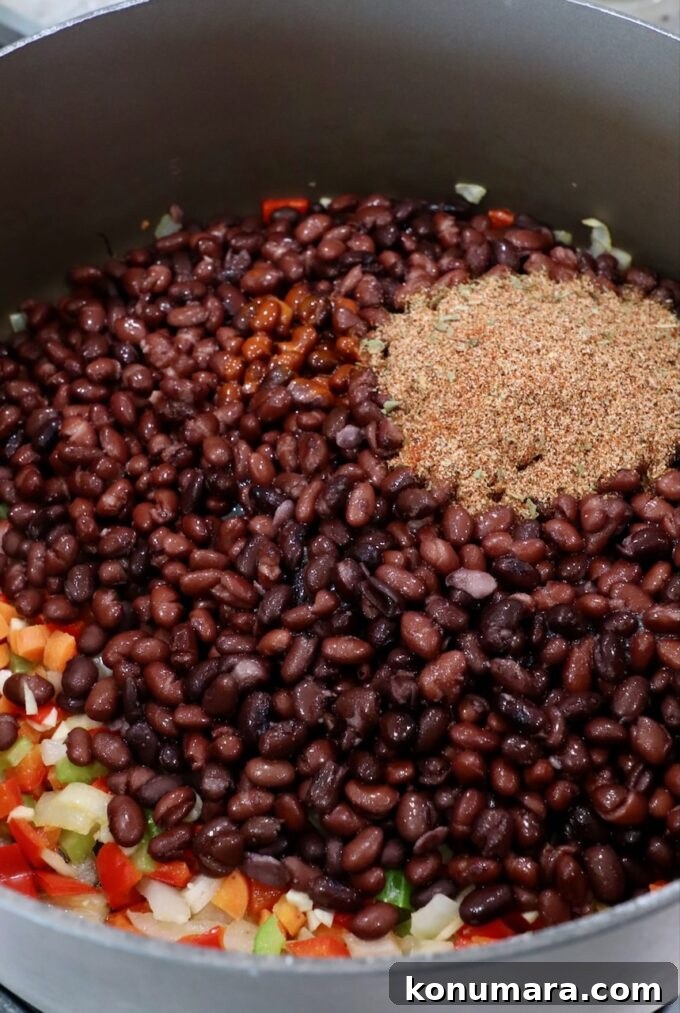 Smoky Southwest Black Bean Soup Recipe 5 black beans in pot on the stove with diced veggies and spices