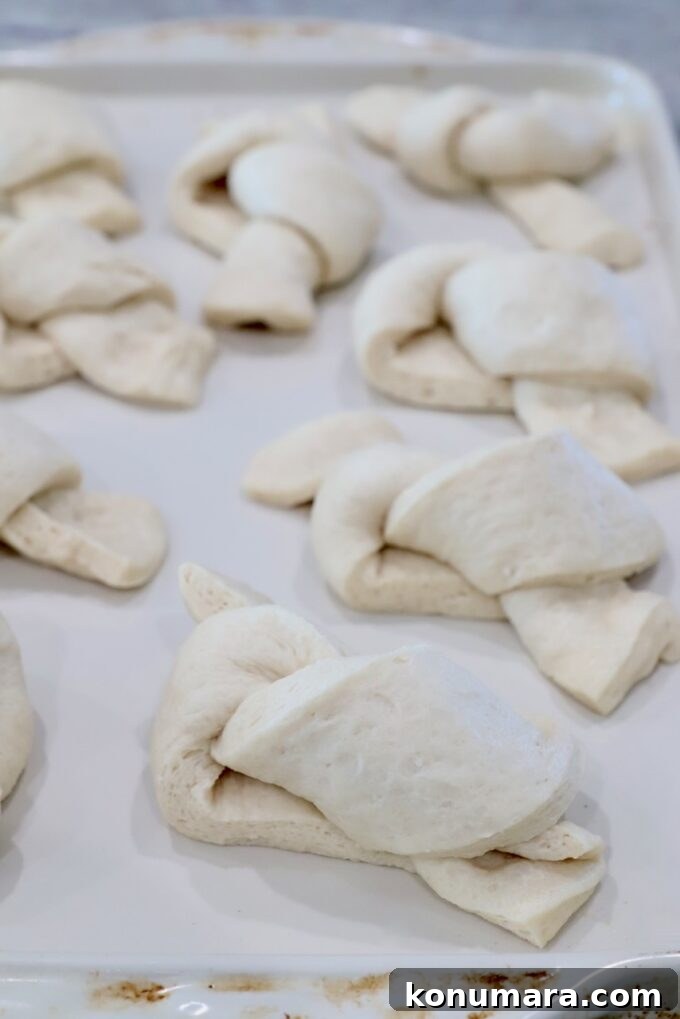 uncooked garlic knots on a baking sheet
