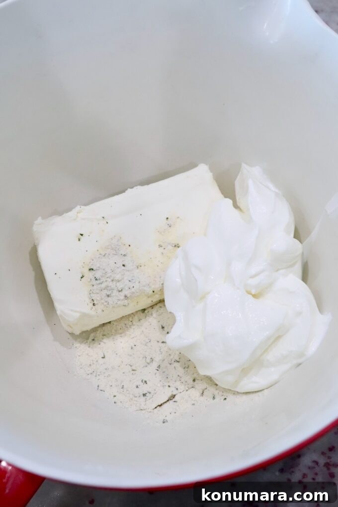 Sour cream, cream cheese and ranch seasoning in a large mixing bowl