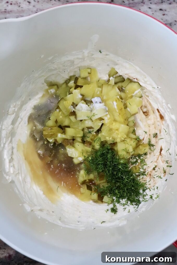 Ingredients for pickle dip in a large bowl