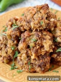 Cheesy Mexican Sausage Balls Recipe with Jalapeno 12 Mexican Chorizo Bisquick Sausage Balls on yellow plate with jalapenos and shredded cheddar cheese