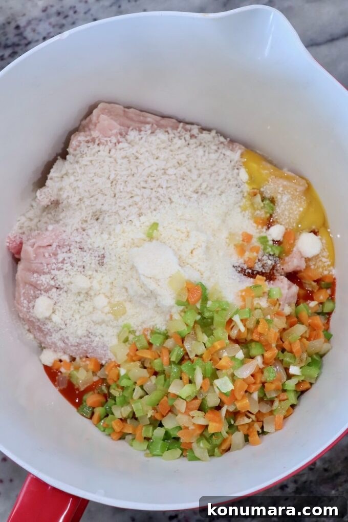 ingredients for buffalo chicken meatballs in a large mixing bowl