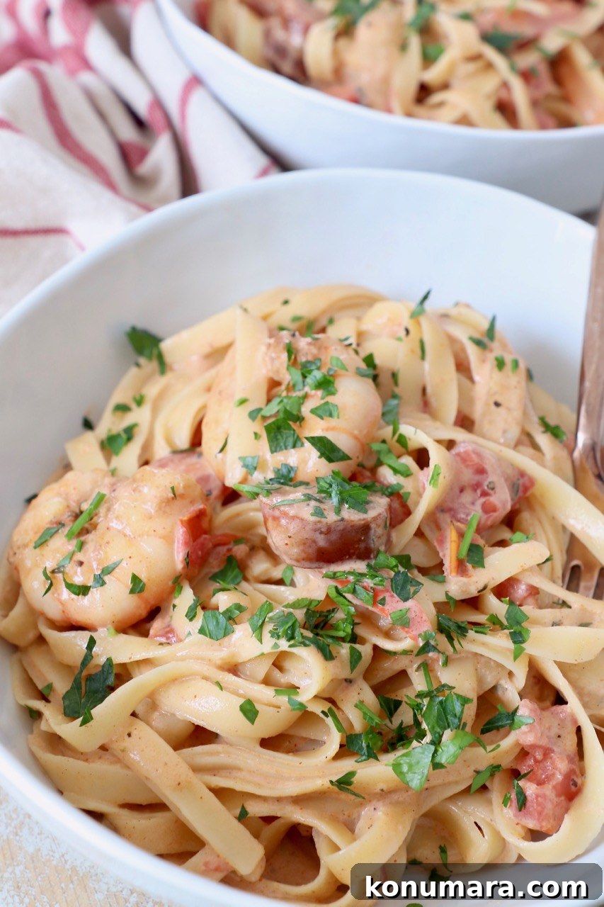 Creamy Cajun Shrimp Pasta with Andouille Sausage 2 cooked pasta in bowl with shrimp and sausage