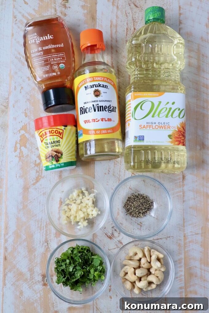 ingredients for tamarind cashew dipping sauce on white wood board