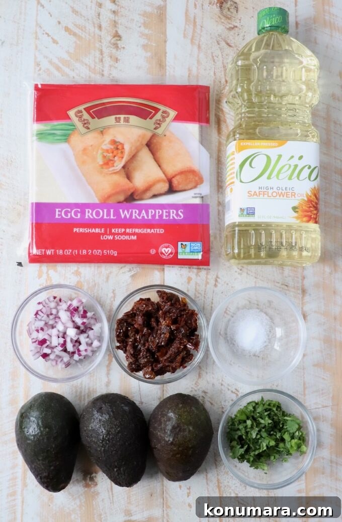 ingredients for avocado egg rolls on white wood board