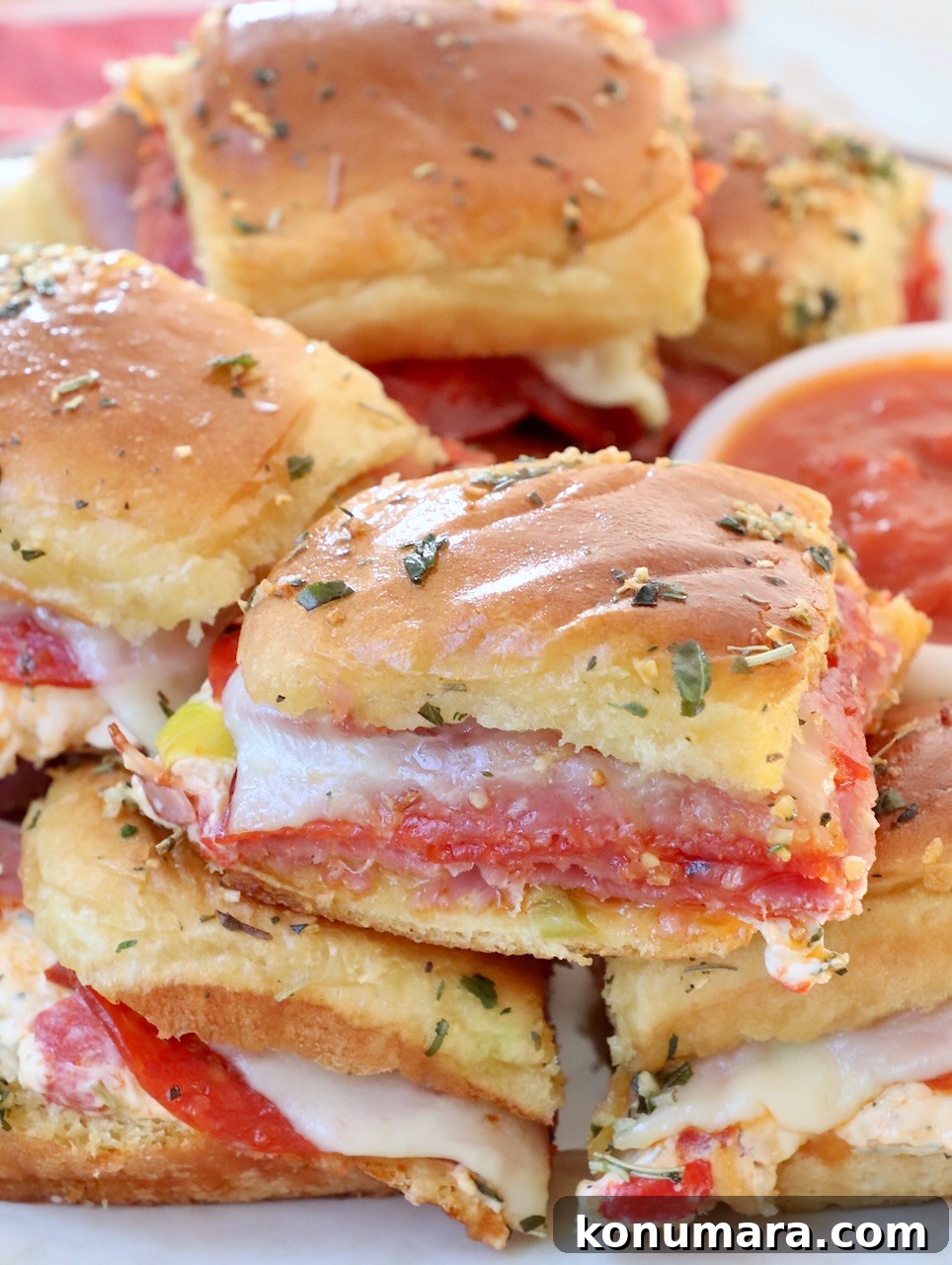 Italian sub sliders stacked up on plate