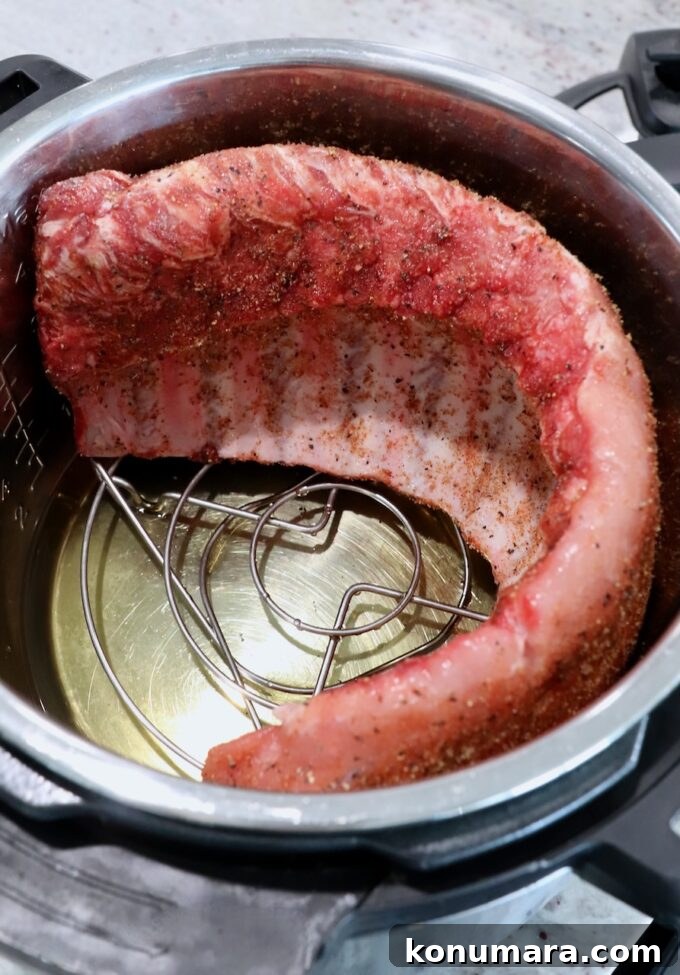 Tender Instant Pot Ribs in 45 Minutes 5 uncooked rack of baby back ribs in Instant Pot