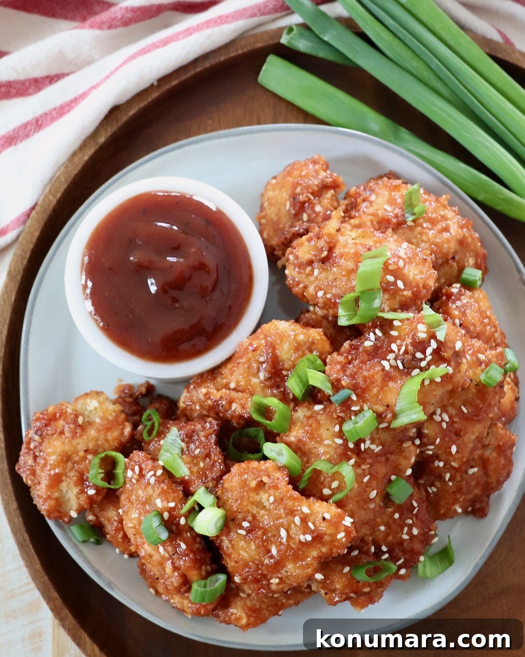 Jack Daniel's BBQ Chicken Strips Recipe 12 cooked, sauced chicken strips on a plate with a small bowl of bbq sauce