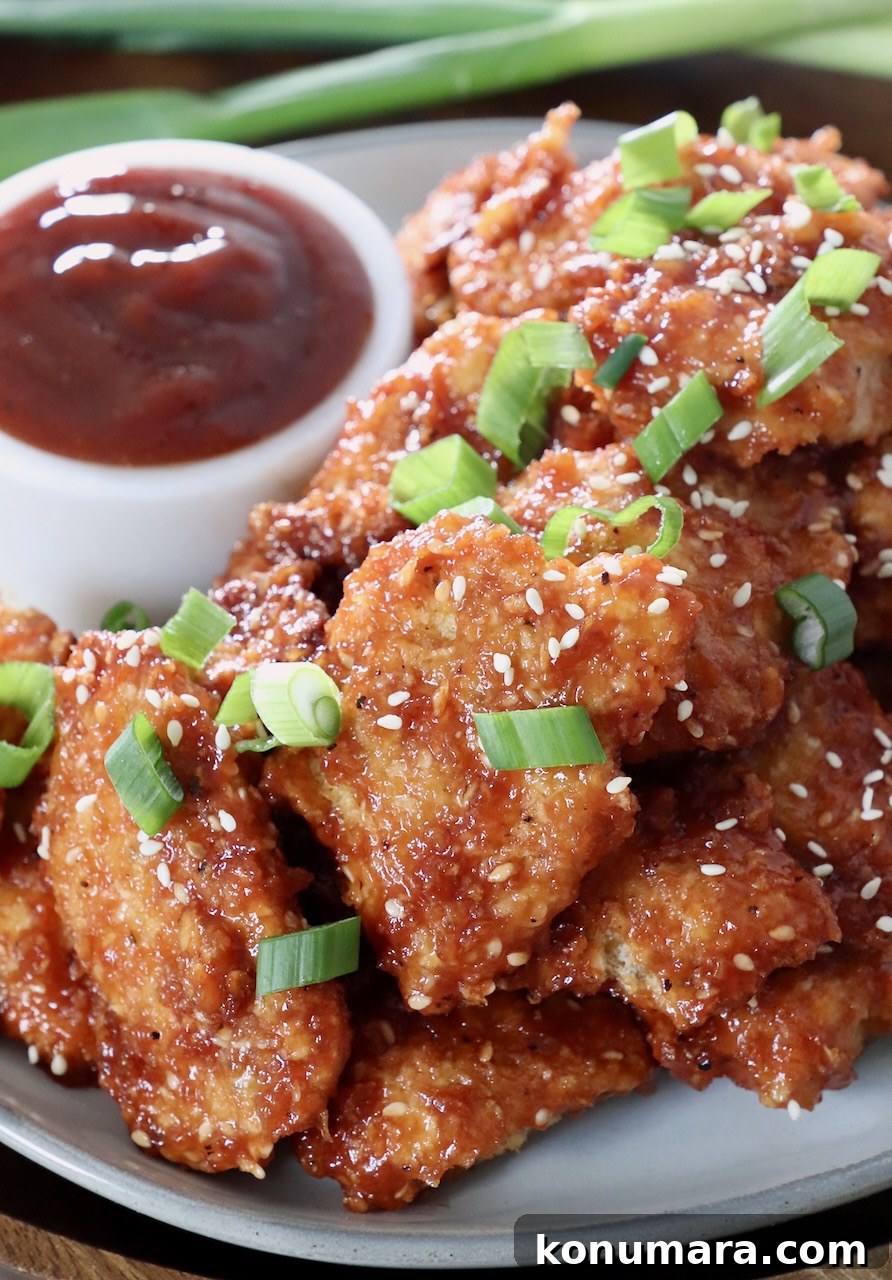 Jack Daniel's BBQ Chicken Strips Recipe 13 breaded, cooked chicken strips tossed with bbq sauce on a plate