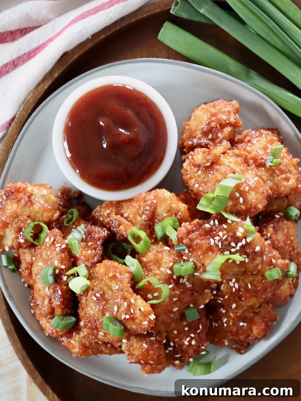 Jack Daniel's BBQ Chicken Strips Recipe 14 crispy chicken strips tossed in whiskey glaze on plate with bbq sauce on the side