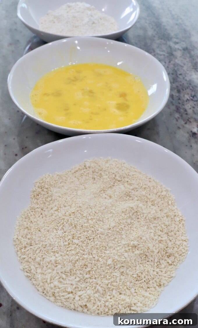 Jack Daniel's BBQ Chicken Strips Recipe 4 three bowls with breadcrumbs in one bowl, whisked eggs in another bowl and flour in the third bowl