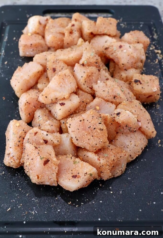 Jack Daniel's BBQ Chicken Strips Recipe 5 pieces of chicken breast meat tossed with seasoning on a cutting board