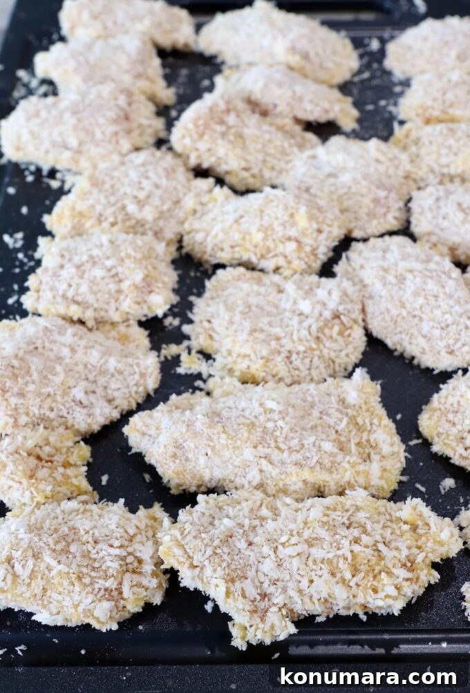 Jack Daniel's BBQ Chicken Strips Recipe 9 battered pieces of chicken on a cutting board