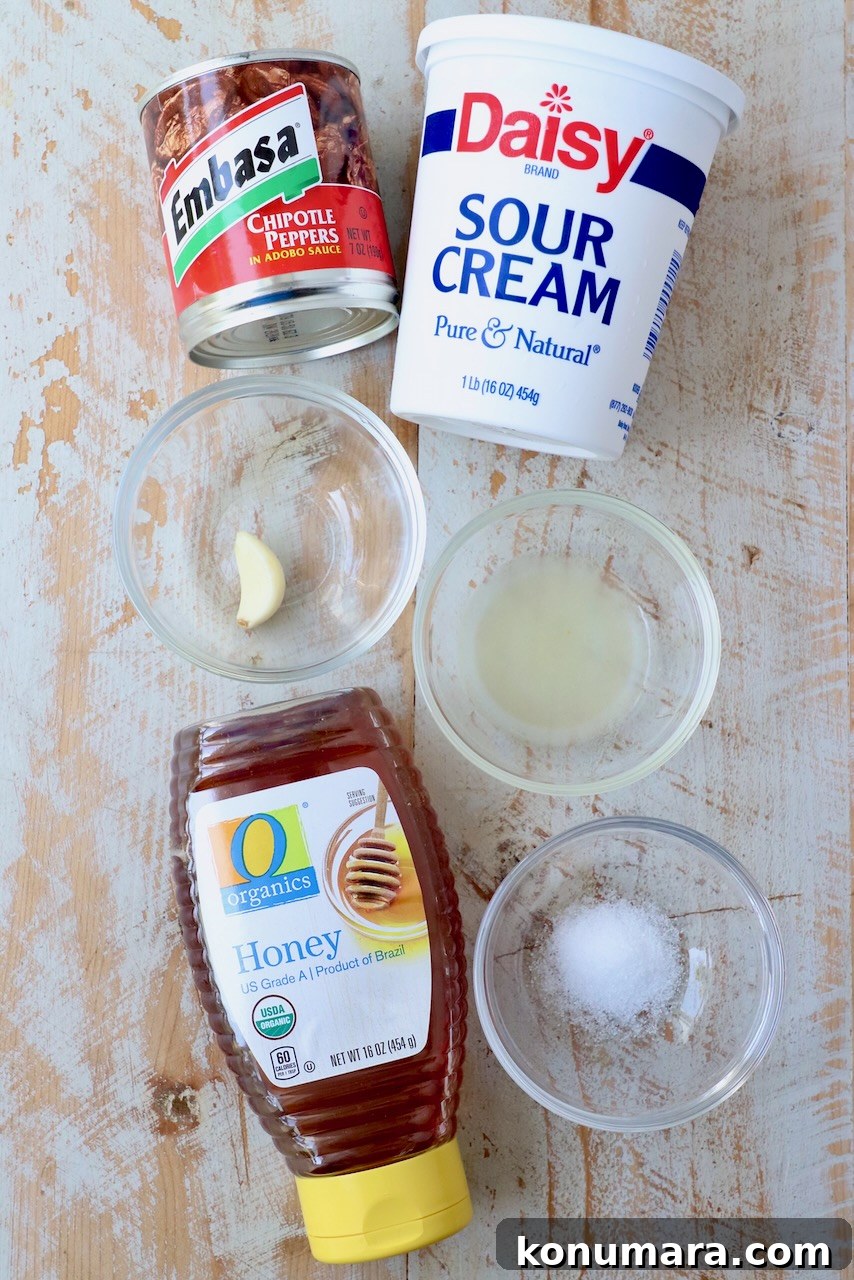 How to Make Smoky Chipotle Sauce for Tacos, Burgers and Dips 3 ingredients for chipotle sauce on white wood board
