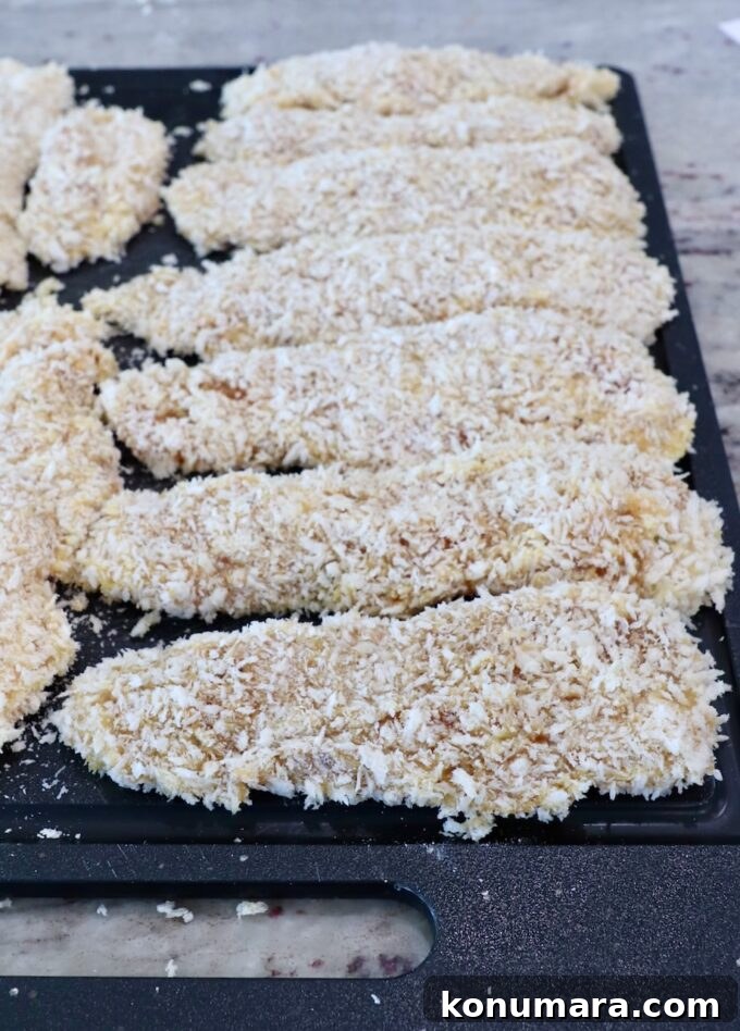 Crispy Air Fryer Chicken Tenders Recipe 9 breaded chicken strips on cutting board